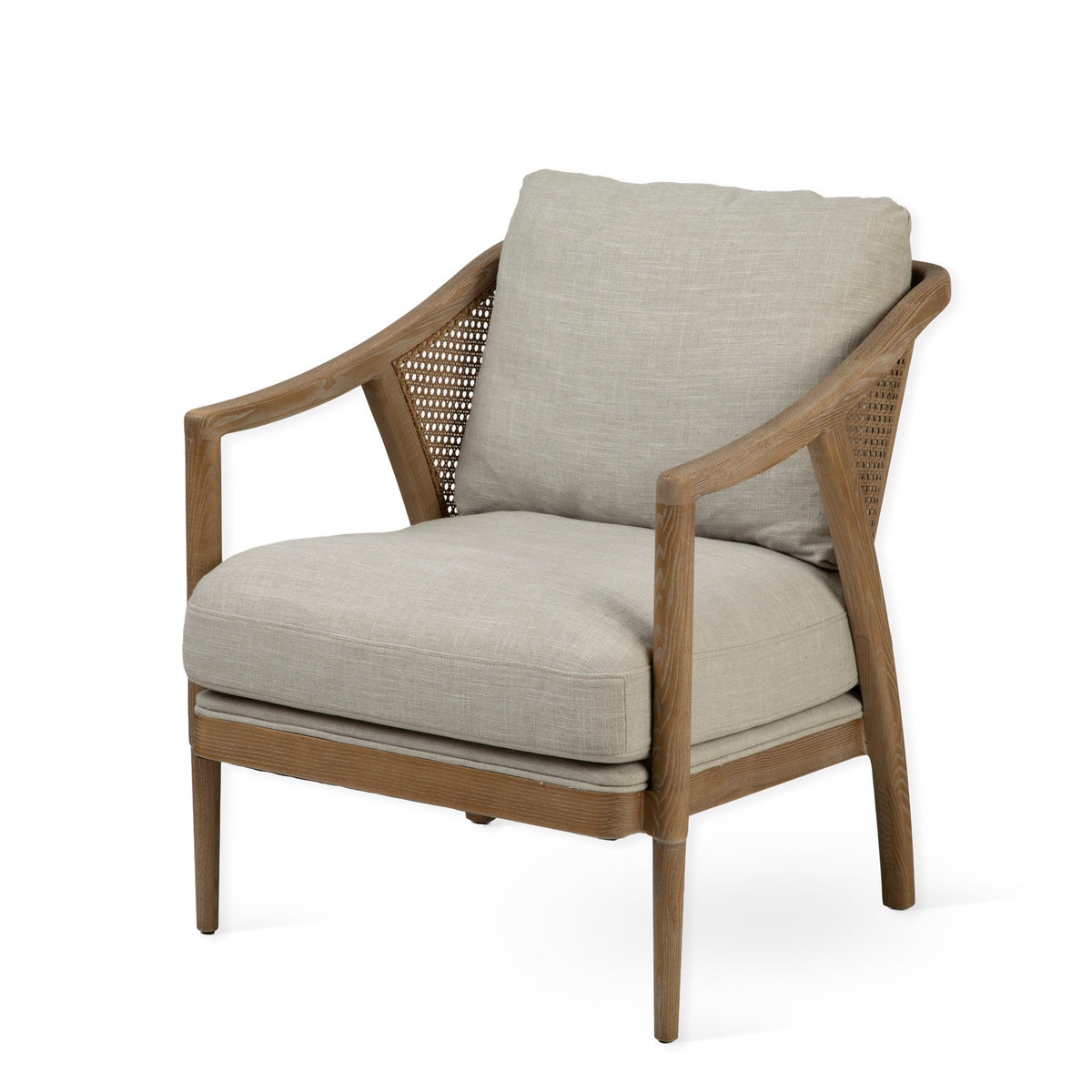 A modern indoor armchair with a light beige linen cushion, a woven cane backrest, and a medium brown wooden frame, shown on a solid white background.