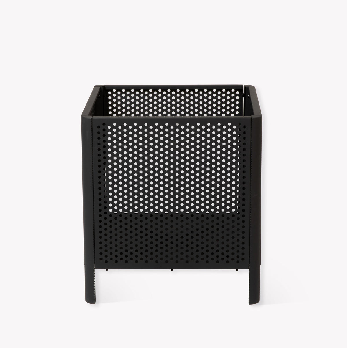 A black metal square fire pit with a perforated mesh design and short legs, shown against a plain white background.